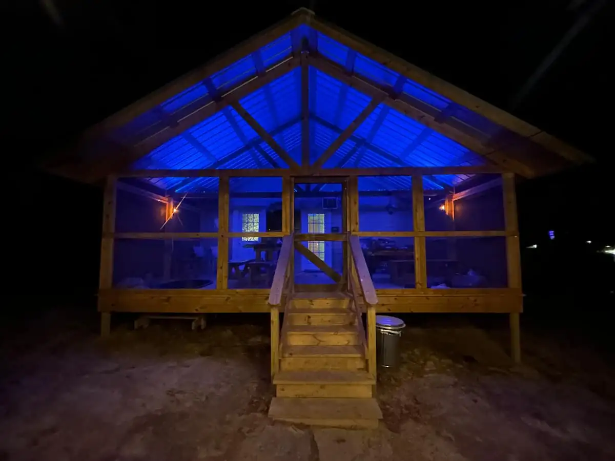 The screened porch glowing at night